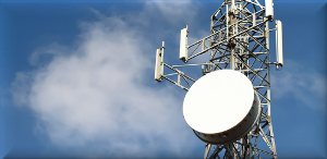 Modern telecommunication tower used for wireless signal transmission, with a clear blue sky in the background.